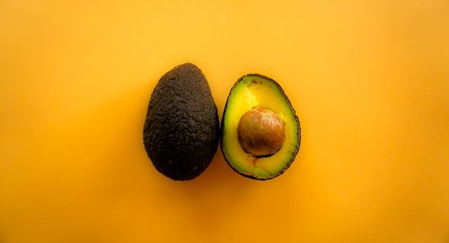 A fresh avocado cut in half