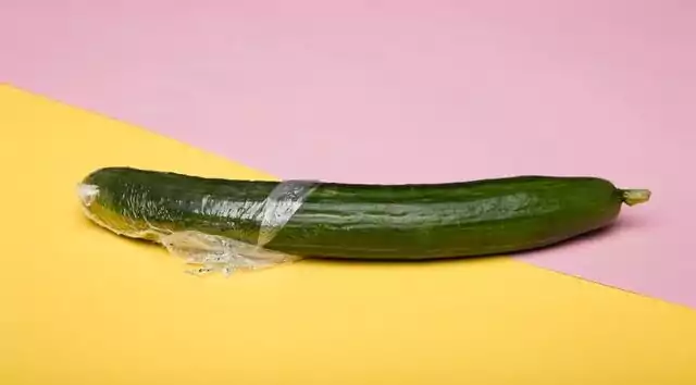 food wrapped in plastic clingfilm in pink and yellow background