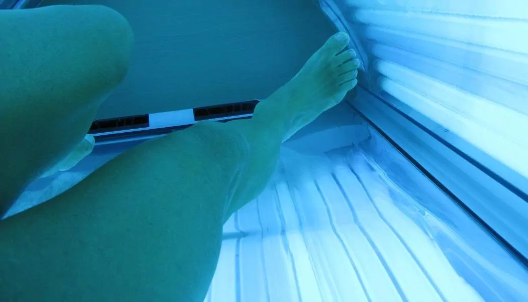 inside a tanning bed with legs photo
