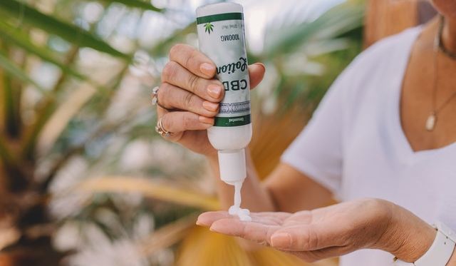 Close Up Of Female Hands Holding Regular Lotion Tube