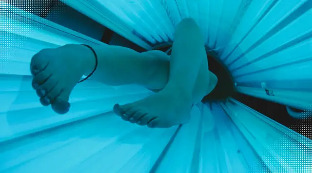 a woman is using a tanning bed after workout