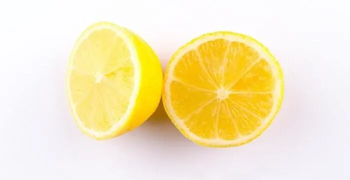 slice of yellow lemon on white background
