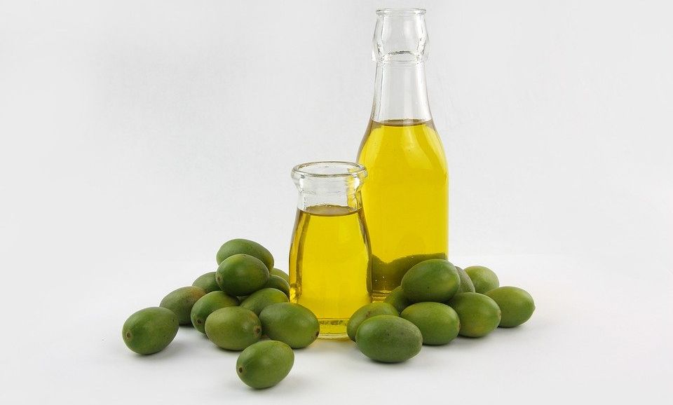 Bottle of olive oil and green olives