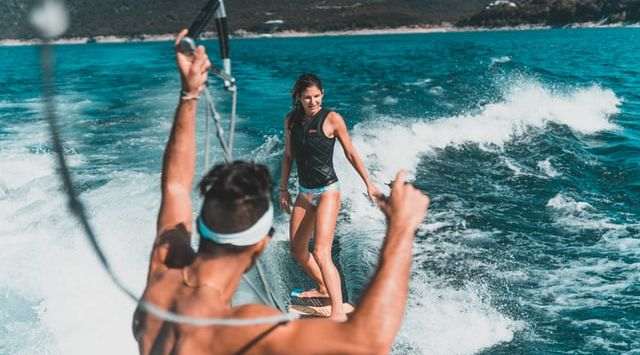 Cheerful women having fun Water Sports in vacation