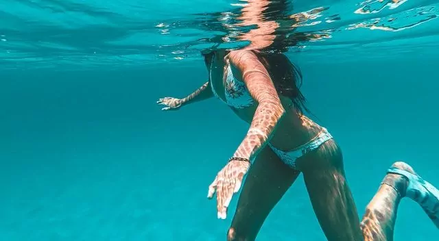 a woman getting tan underwater